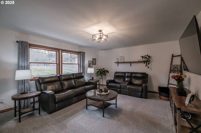 living room with a chandelier and carpet flooring