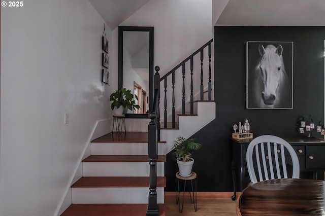 stairway featuring baseboards and wood finished floors