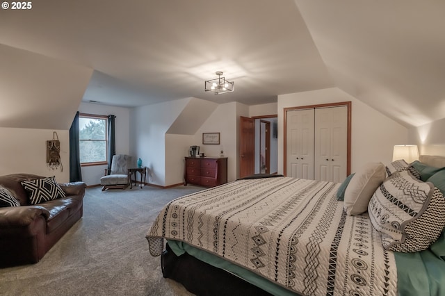 bedroom with vaulted ceiling, a closet, carpet, and baseboards