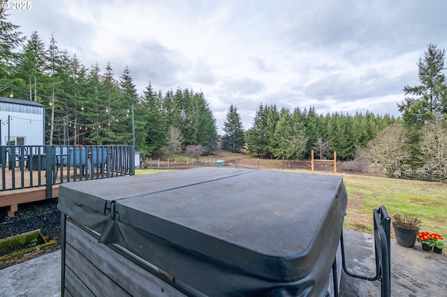 view of pool with fence, a hot tub, and a wooden deck