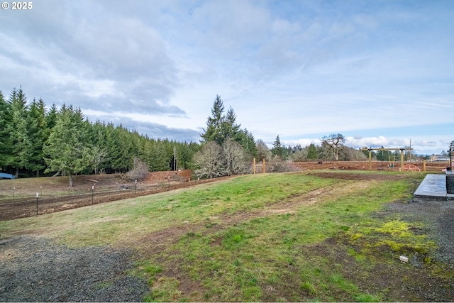 view of yard with a rural view and fence