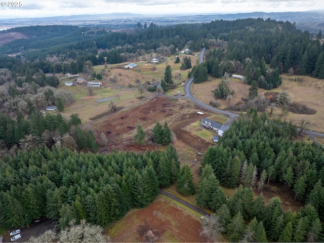 drone / aerial view featuring a view of trees