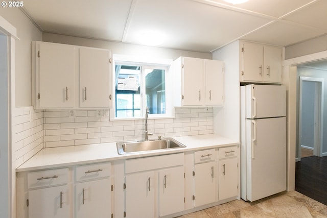 207 N Maple St, Bingen, WA 98605 - kitchen featuring freestanding refrigerator, decorative backsplash, light countertops, white cabinetry, and a sink