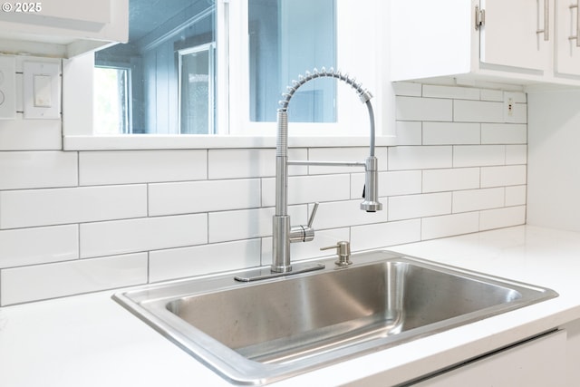 207 N Maple St, Bingen, WA 98605 - interior details with a sink, white cabinetry, decorative backsplash, and light countertops
