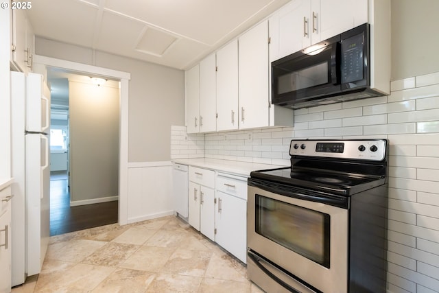 207 N Maple St, Bingen, WA 98605 - kitchen featuring tasteful backsplash, light countertops, a wainscoted wall, white appliances, and white cabinetry