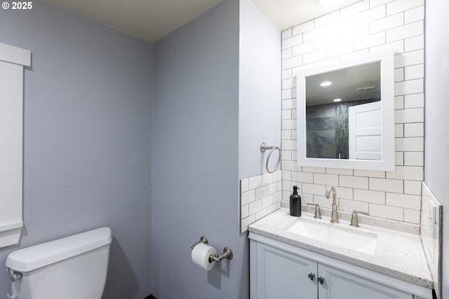 207 N Maple St, Bingen, WA 98605 - bathroom featuring toilet, decorative backsplash, and vanity