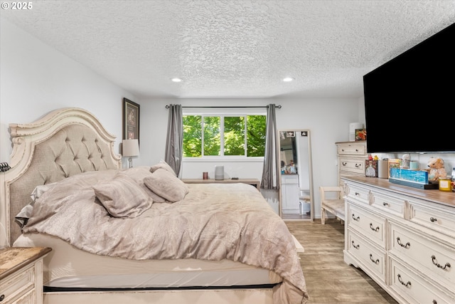 22165 SE Mark Rd, Damascus, OR 97089 - bedroom with light wood finished floors, a textured ceiling, and recessed lighting