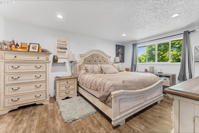 22165 SE Mark Rd, Damascus, OR 97089 - bedroom featuring wood finished floors, a textured ceiling, and recessed lighting