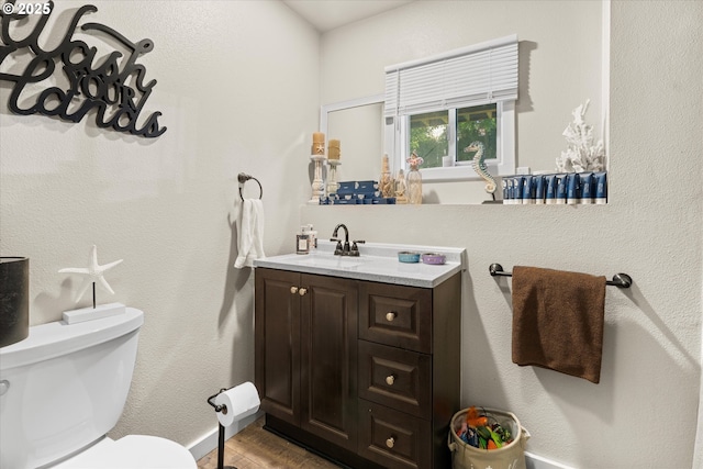 22165 SE Mark Rd, Damascus, OR 97089 - bathroom featuring toilet, vanity, wood finished floors, and baseboards
