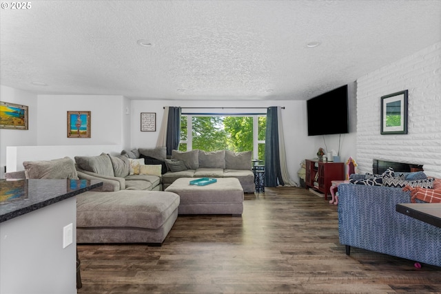 22165 SE Mark Rd, Damascus, OR 97089 - living area with a textured ceiling, dark wood-style flooring, and a fireplace