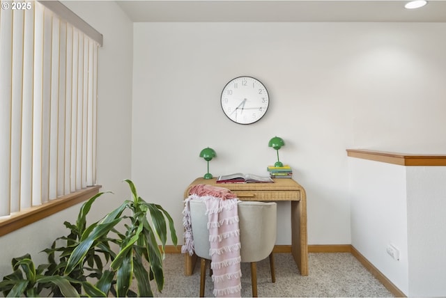 carpeted office space featuring baseboards