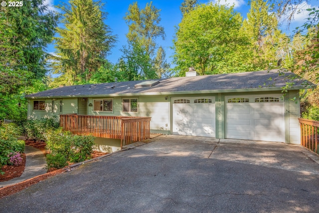 19065 Trillium Dr, West Linn, OR 97068 - ranch-style house with asphalt driveway, a chimney, an attached garage, a wooden deck, and a shingled roof