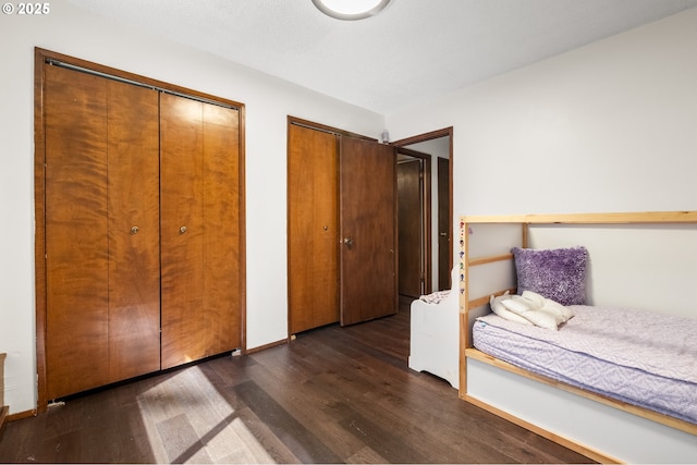 19065 Trillium Dr, West Linn, OR 97068 - bedroom with two closets and dark wood-type flooring