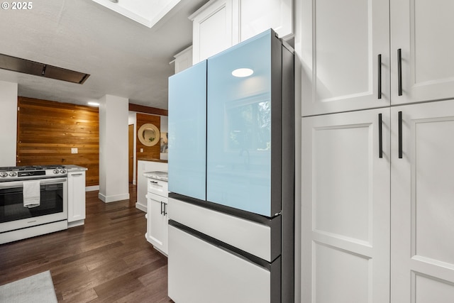 19065 Trillium Dr, West Linn, OR 97068 - kitchen featuring stainless steel range oven, wooden walls, white cabinetry, dark wood-style floors, and light countertops
