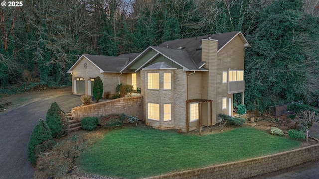 view of front of home featuring a garage and a front yard