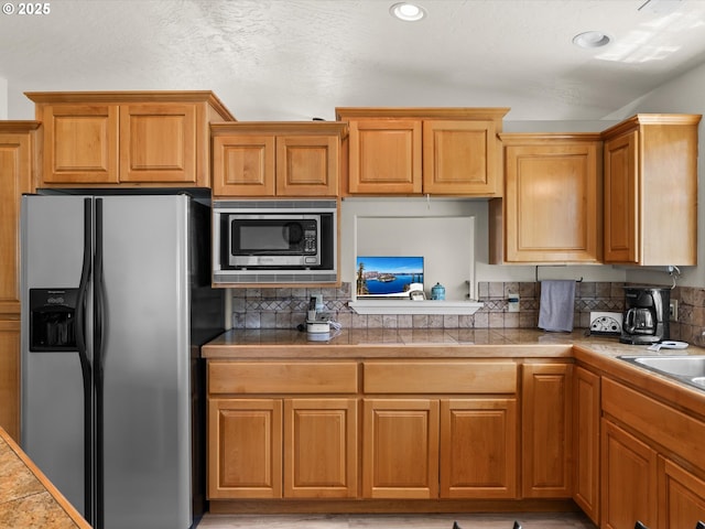 6759 Jasmine Ct, Brookings, OR 97415 - kitchen with recessed lighting, stainless steel appliances, brown cabinetry, and backsplash