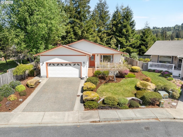 6759 Jasmine Ct, Brookings, OR 97415 - single story home with aphalt driveway, fence, and a garage