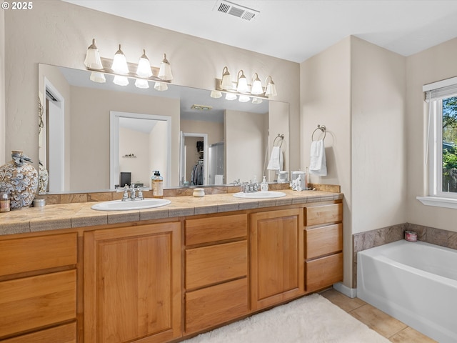 6759 Jasmine Ct, Brookings, OR 97415 - bathroom with double vanity, tile patterned floors, visible vents, and a sink
