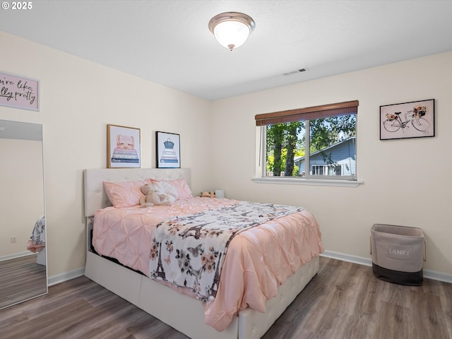 6759 Jasmine Ct, Brookings, OR 97415 - bedroom with visible vents, wood finished floors, and baseboards