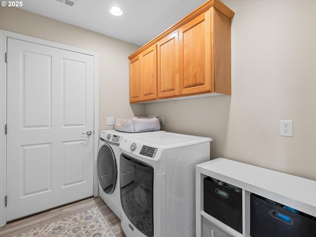 6759 Jasmine Ct, Brookings, OR 97415 - laundry area featuring washing machine and clothes dryer, light wood-style flooring, cabinet space, and recessed lighting