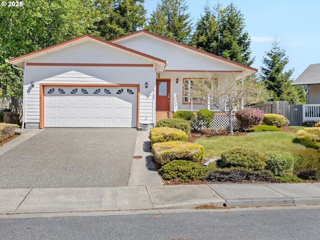 6759 Jasmine Ct, Brookings, OR 97415 - ranch-style house with fence, covered porch, a garage, aphalt driveway, and a front lawn