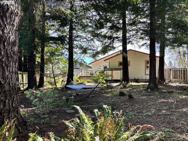 6759 Jasmine Ct, Brookings, OR 97415 - view of side of property with a deck and fence