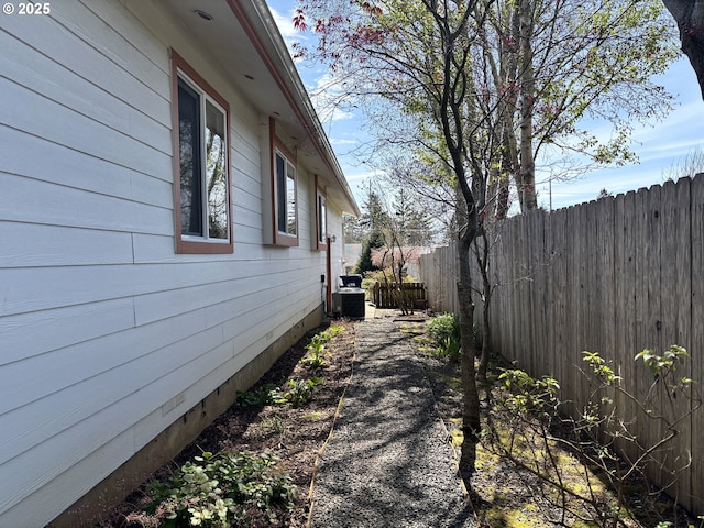 6759 Jasmine Ct, Brookings, OR 97415 - view of side of property with fence and central AC