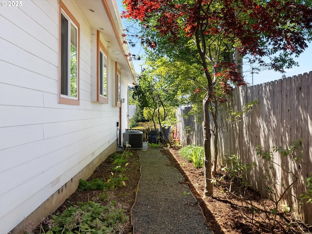 6759 Jasmine Ct, Brookings, OR 97415 - view of side of property with cooling unit and a fenced backyard