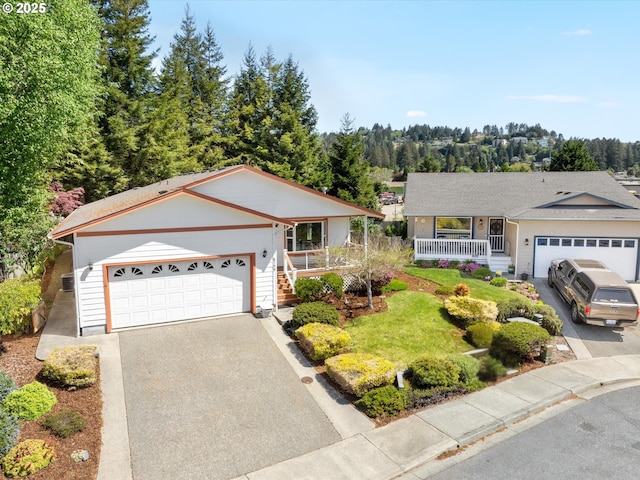 6759 Jasmine Ct, Brookings, OR 97415 - single story home featuring covered porch, aphalt driveway, stairs, and a garage