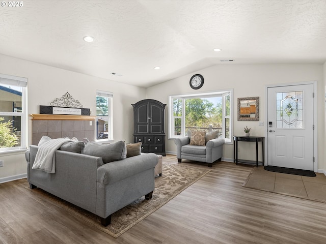 6759 Jasmine Ct, Brookings, OR 97415 - living area with lofted ceiling, a wealth of natural light, a textured ceiling, and wood finished floors
