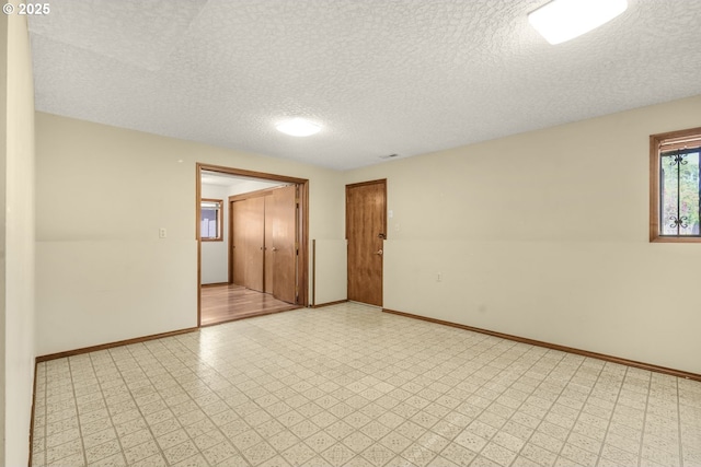 14428 NE Failing St, Portland, OR 97230 - spare room with a textured ceiling and light floors