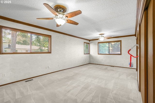 14428 NE Failing St, Portland, OR 97230 - spare room with ceiling fan, light colored carpet, ornamental molding, and a textured ceiling