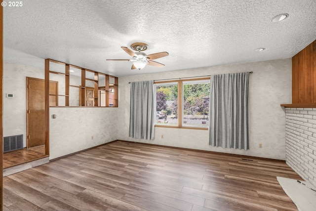14428 NE Failing St, Portland, OR 97230 - unfurnished living room featuring a ceiling fan, wood finished floors, and a textured ceiling