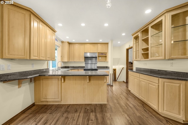 14428 NE Failing St, Portland, OR 97230 - kitchen with under cabinet range hood, a peninsula, open shelves, light brown cabinetry, and dark wood-type flooring