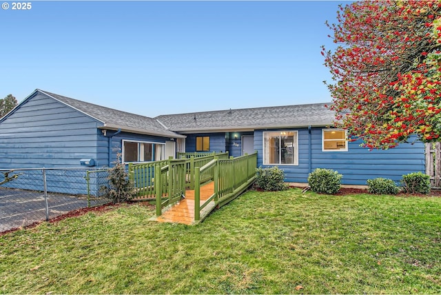 view of front of house with a wooden deck and a front yard