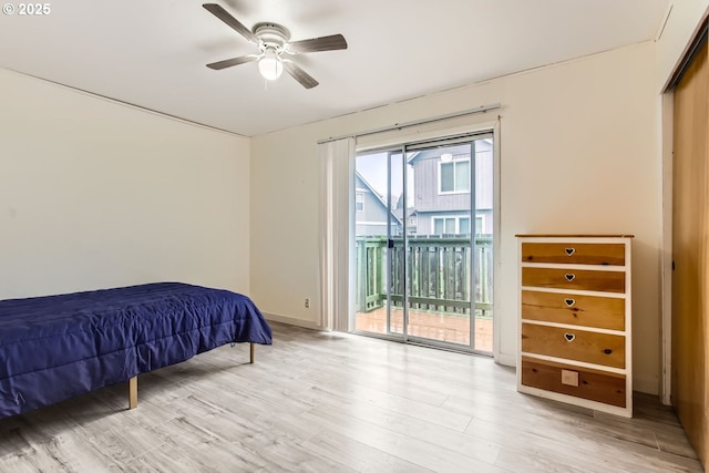 bedroom featuring ceiling fan, light hardwood / wood-style floors, and access to outside