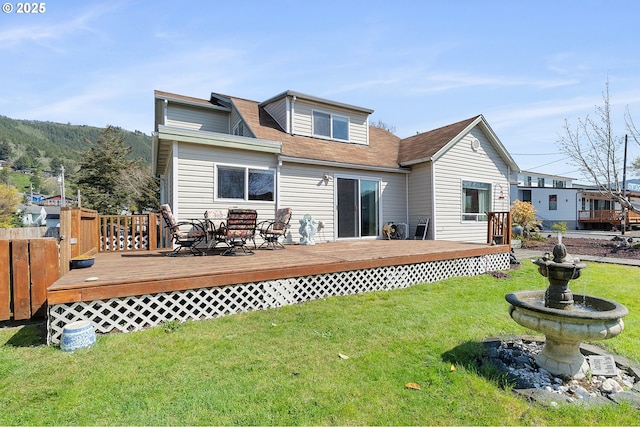 107 4th St, Garibaldi, OR 97118 - rear view of property featuring a lawn and a deck