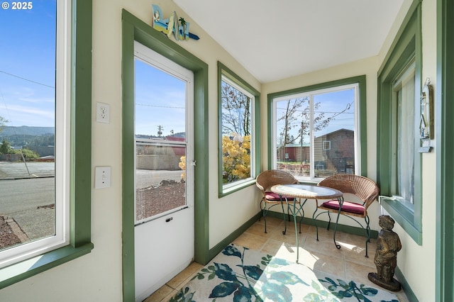 107 4th St, Garibaldi, OR 97118 - sunroom with healthy amount of natural light, tile patterned flooring, and baseboards