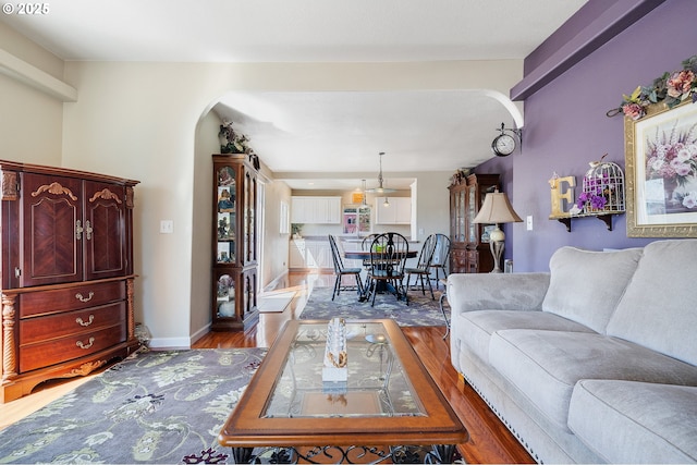 107 4th St, Garibaldi, OR 97118 - living area featuring wood finished floors, arched walkways, and baseboards