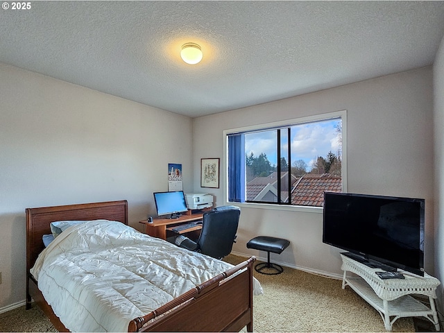 carpeted bedroom featuring baseboards and a textured ceiling