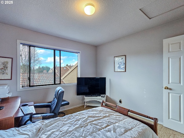 carpeted bedroom with baseboards and a textured ceiling