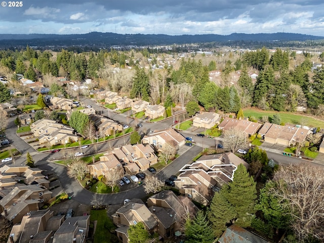 drone / aerial view with a residential view and a view of trees