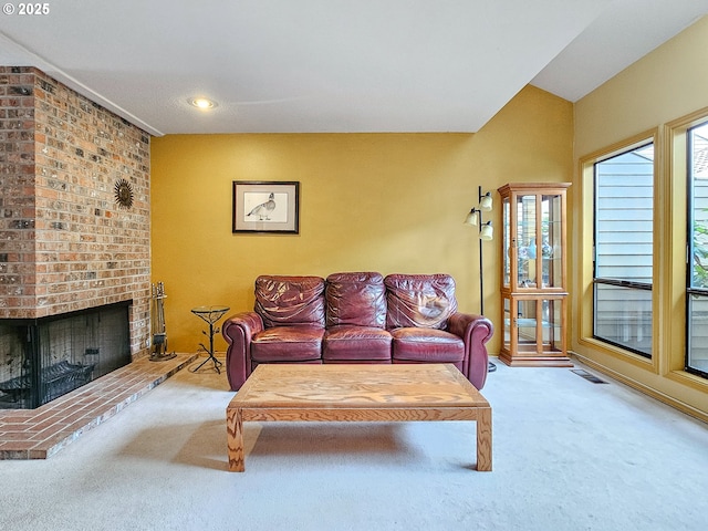 living room with carpet floors, recessed lighting, visible vents, and a fireplace