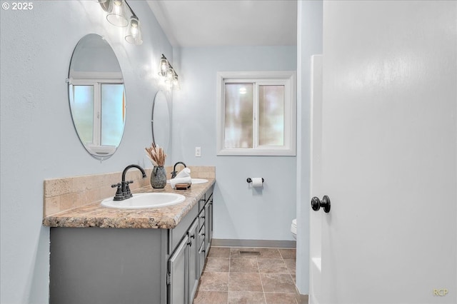 513 SE 103rd Ave, Vancouver, WA 98664 - full bath with double vanity, baseboards, toilet, and stone finish flooring