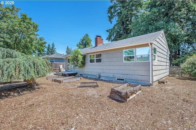 513 SE 103rd Ave, Vancouver, WA 98664 - rear view of property featuring a vegetable garden and a chimney