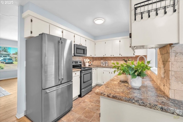 513 SE 103rd Ave, Vancouver, WA 98664 - kitchen featuring appliances with stainless steel finishes, tasteful backsplash, and white cabinetry