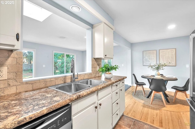 513 SE 103rd Ave, Vancouver, WA 98664 - kitchen with a sink, backsplash, stainless steel dishwasher, and white cabinets