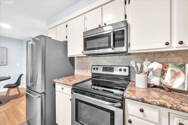 513 SE 103rd Ave, Vancouver, WA 98664 - kitchen with stainless steel appliances, white cabinetry, decorative backsplash, wood finished floors, and light stone counters