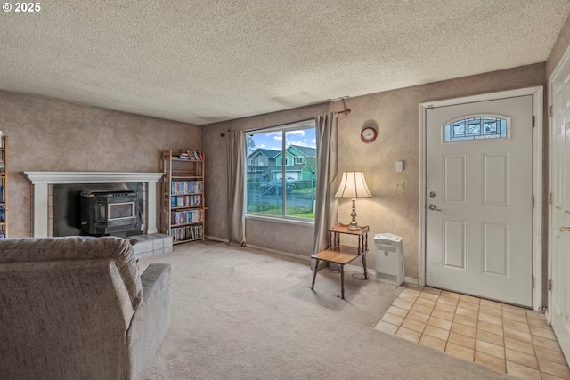 interior space featuring baseboards, carpet floors, a textured ceiling, and a wood stove