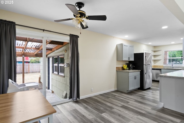 4220 SE 130th Ave, Portland, OR 97236 - kitchen with light wood-style floors, stainless steel appliances, a ceiling fan, recessed lighting, and gray cabinets